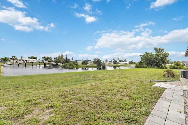 view of yard featuring a dock and a water view