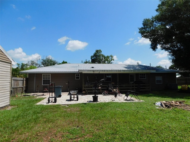 back of house featuring a yard and a patio