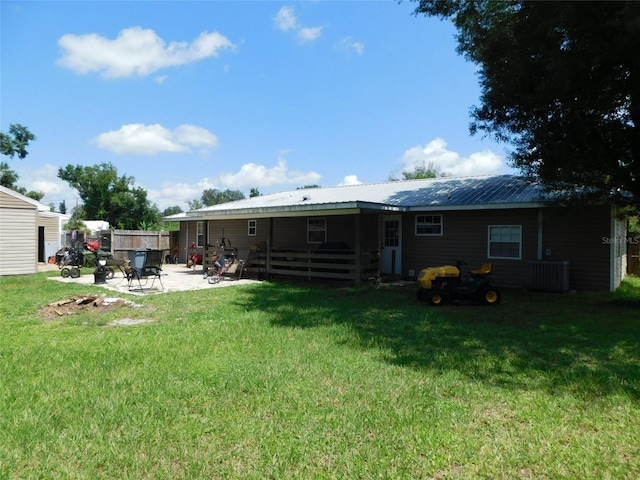 rear view of house featuring a patio, a yard, and central air condition unit