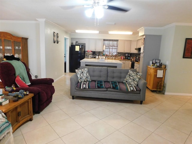 living room featuring ceiling fan, crown molding, and light tile patterned floors