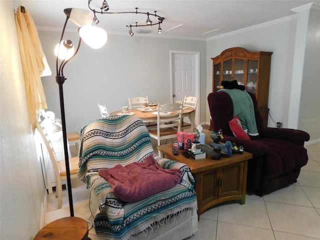 sitting room with crown molding, light tile patterned floors, and rail lighting