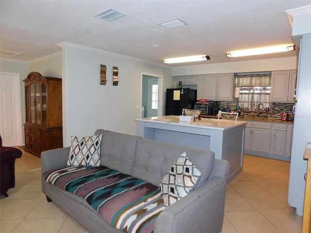 tiled living room featuring ornamental molding