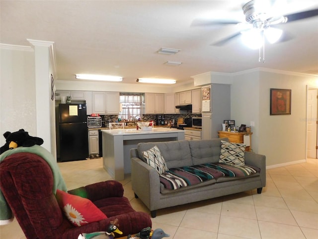 living room featuring ceiling fan, light tile patterned flooring, and ornamental molding