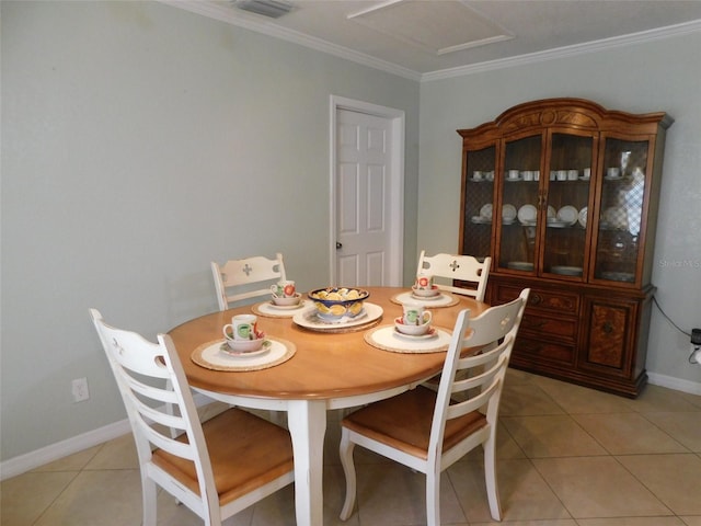 dining room with ornamental molding and light tile patterned floors