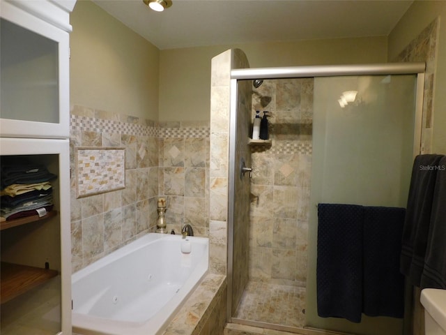 bathroom featuring shower with separate bathtub and toilet