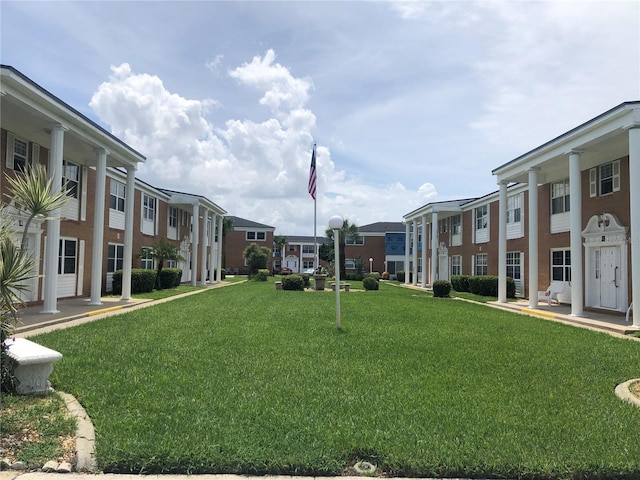 surrounding community featuring a lawn and a residential view