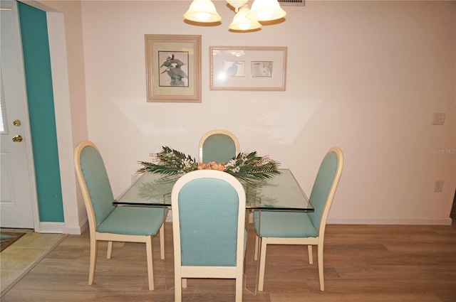 dining room featuring a chandelier and wood-type flooring