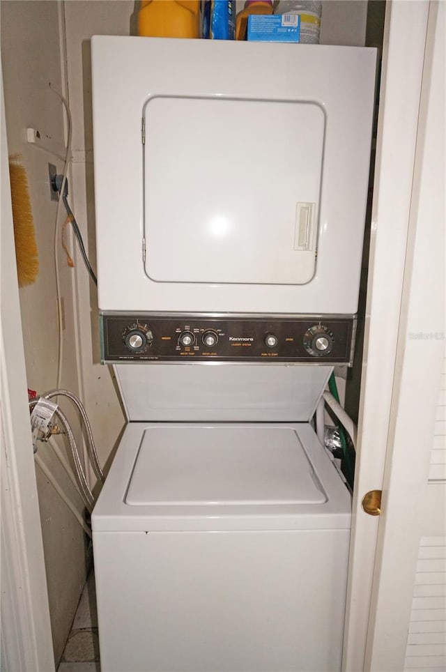 laundry room with stacked washing maching and dryer