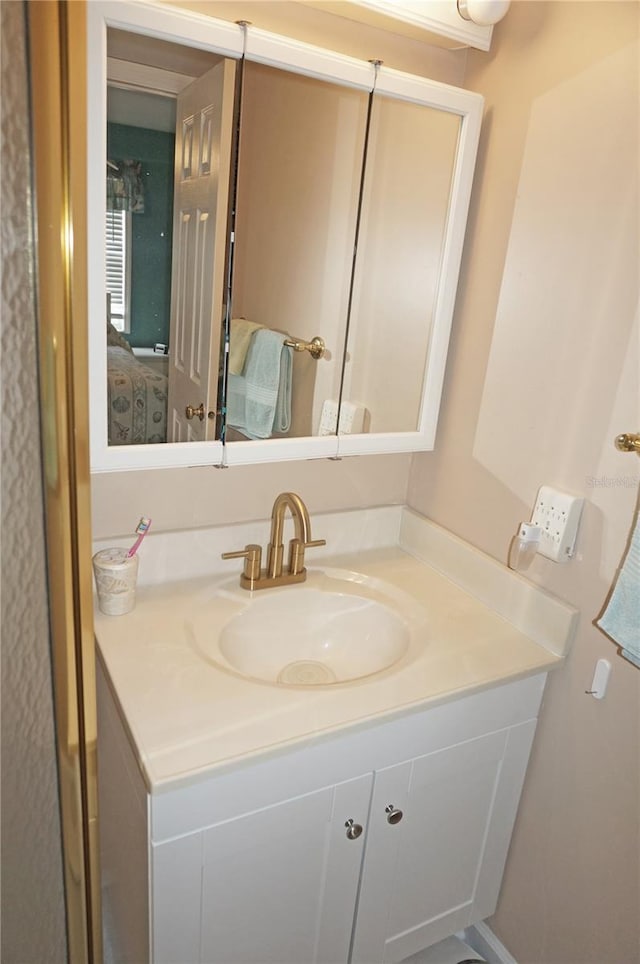 bathroom with connected bathroom and vanity