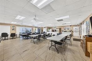 dining area featuring light tile patterned floors, a drop ceiling, and ceiling fan