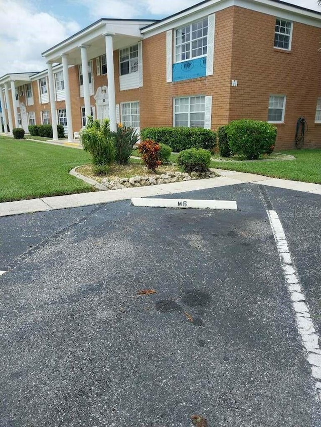 view of car parking with a yard