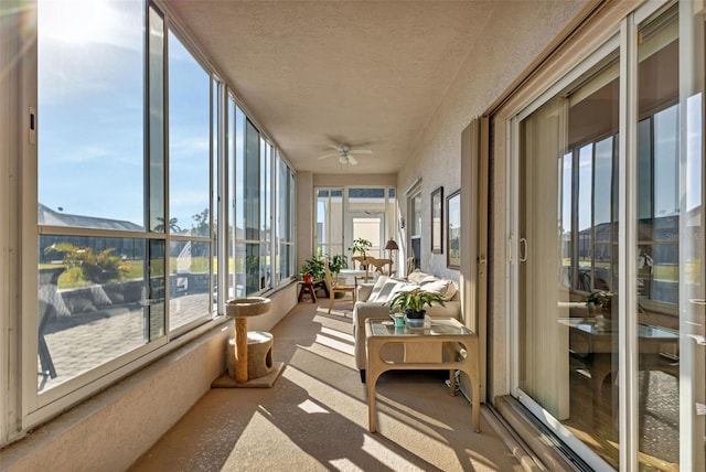 sunroom / solarium featuring ceiling fan and a healthy amount of sunlight