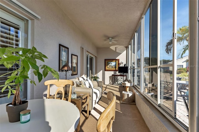 sunroom / solarium featuring ceiling fan