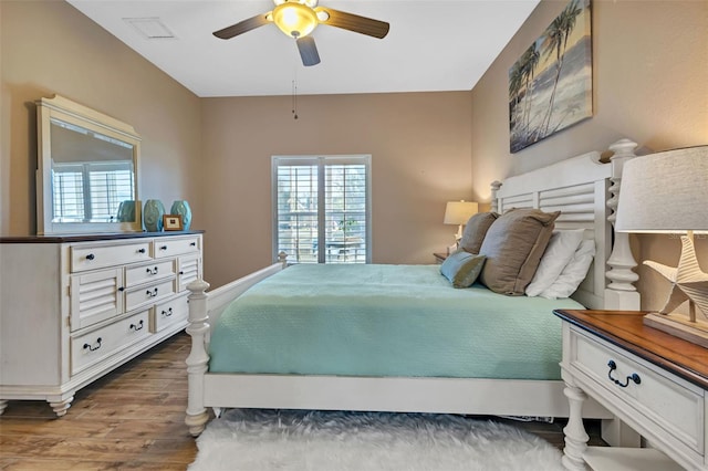 bedroom with ceiling fan and dark wood-type flooring