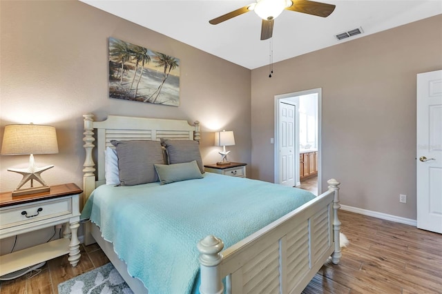 bedroom with ceiling fan, ensuite bathroom, and wood-type flooring