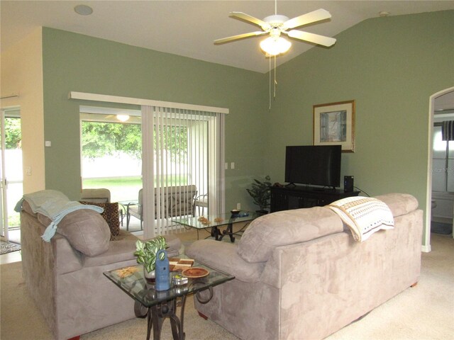 carpeted living room with a wealth of natural light, lofted ceiling, and ceiling fan