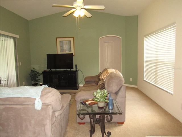 carpeted living room featuring ceiling fan and lofted ceiling