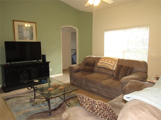 living room with carpet floors, ceiling fan, and vaulted ceiling