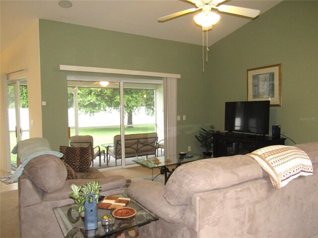 carpeted living room featuring ceiling fan and vaulted ceiling