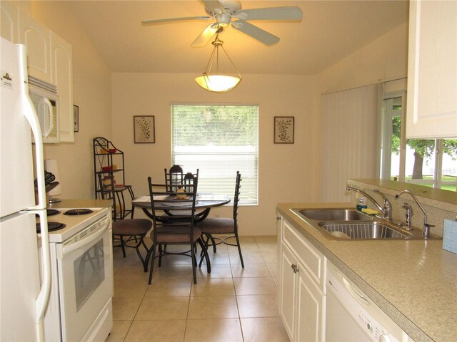 kitchen featuring a wealth of natural light, white cabinets, and light tile patterned floors