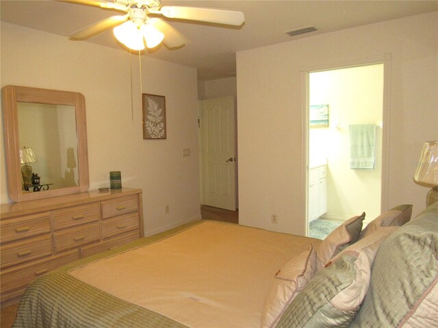 bedroom with ceiling fan and ensuite bath