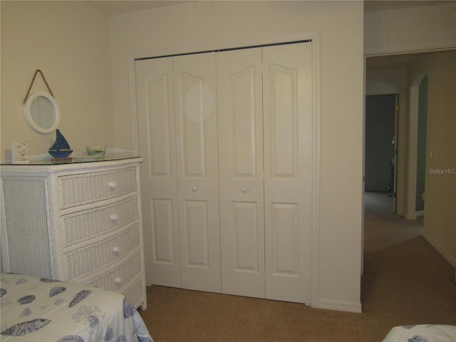 carpeted bedroom with a closet