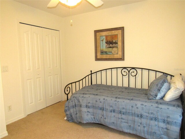 bedroom featuring ceiling fan, a closet, and carpet floors