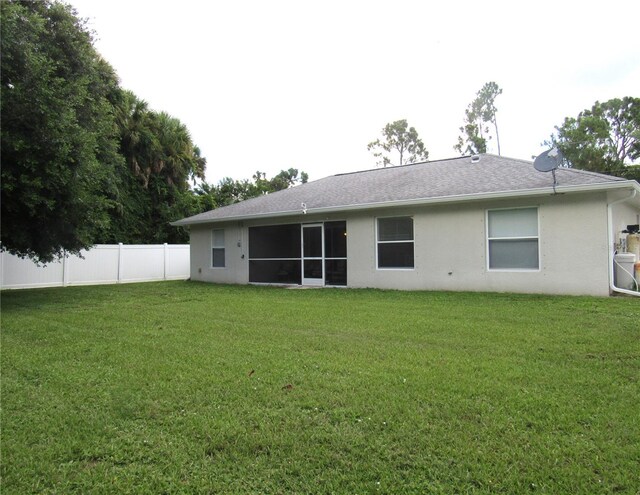 back of property featuring a lawn