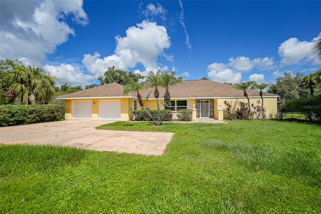 ranch-style home featuring a garage and a front yard