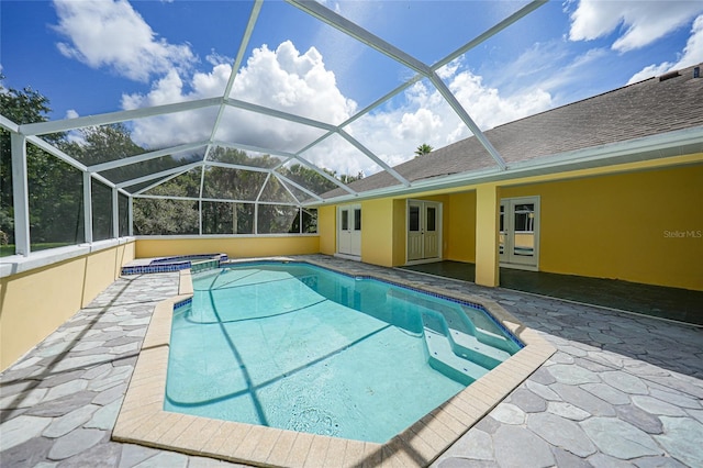 view of swimming pool with a patio area, a lanai, and a pool with connected hot tub