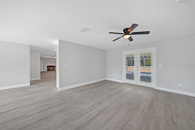 spare room featuring light hardwood / wood-style floors, french doors, and ceiling fan