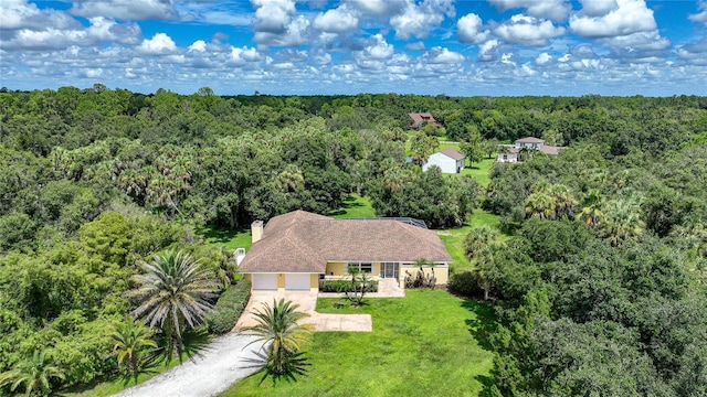 birds eye view of property featuring a view of trees