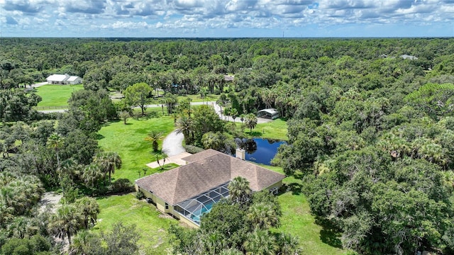 aerial view with a water view and a wooded view