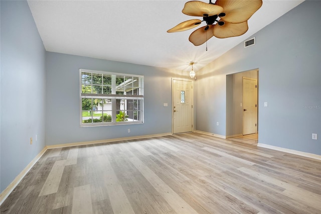 empty room featuring lofted ceiling, ceiling fan, and light wood-type flooring