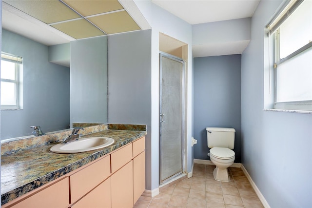 bathroom featuring tile patterned flooring, vanity, toilet, and a shower with shower door