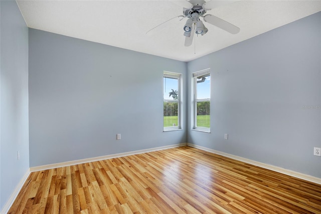 unfurnished room with hardwood / wood-style flooring and ceiling fan