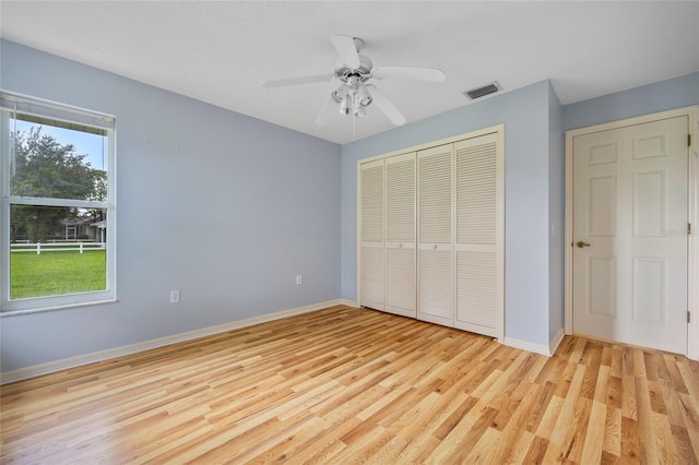 unfurnished bedroom with multiple windows, ceiling fan, and light hardwood / wood-style floors