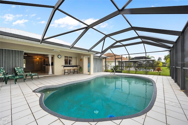 view of swimming pool featuring a lanai and a patio area