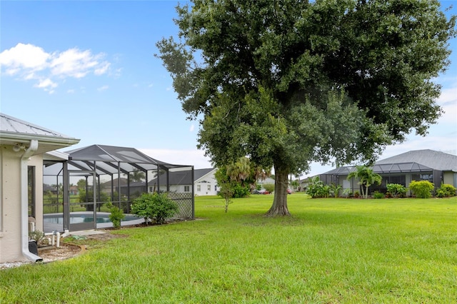 view of yard with glass enclosure