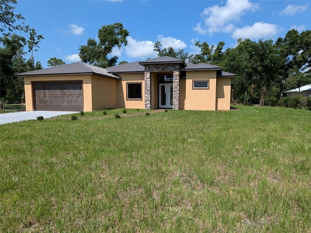 prairie-style home featuring a front yard, stucco siding, a garage, stone siding, and metal roof
