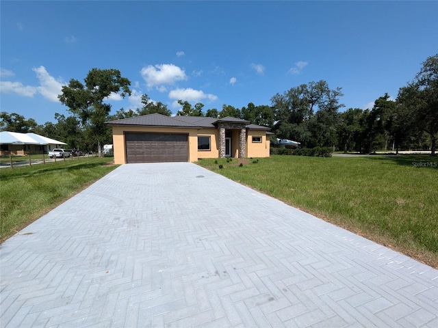 view of front of house with stucco siding, an attached garage, decorative driveway, and a front yard