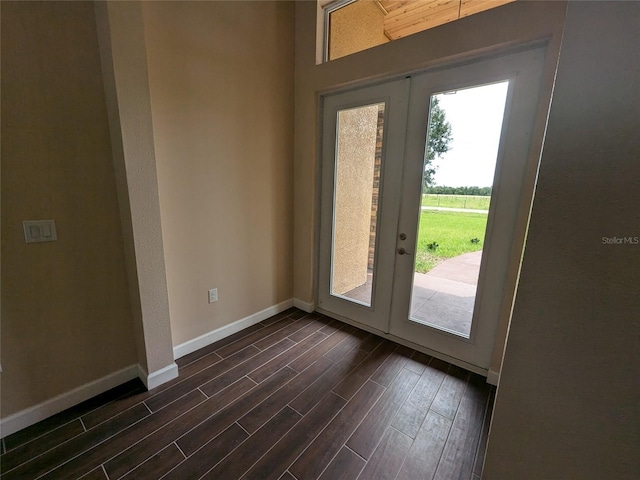 doorway featuring dark wood-style floors, french doors, and baseboards