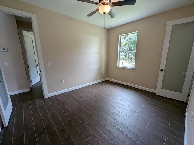 spare room with ceiling fan and dark wood-type flooring