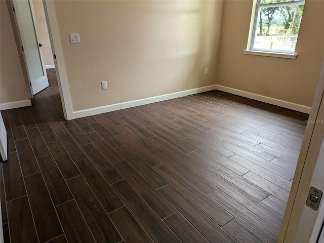 unfurnished room featuring wood finish floors and baseboards