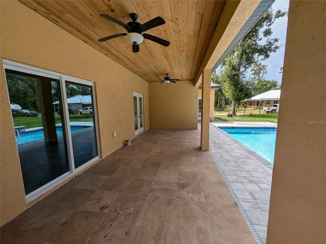 pool featuring french doors, a patio, and a ceiling fan