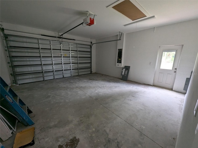 garage with electric panel and a garage door opener