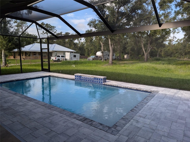 view of pool with a lanai, a patio, and a yard