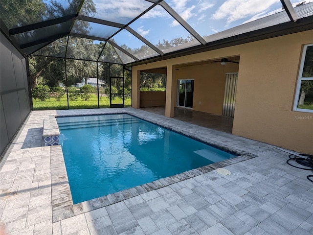 view of pool featuring a lanai, ceiling fan, and a patio area