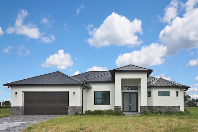 view of front of house with a garage and a front yard