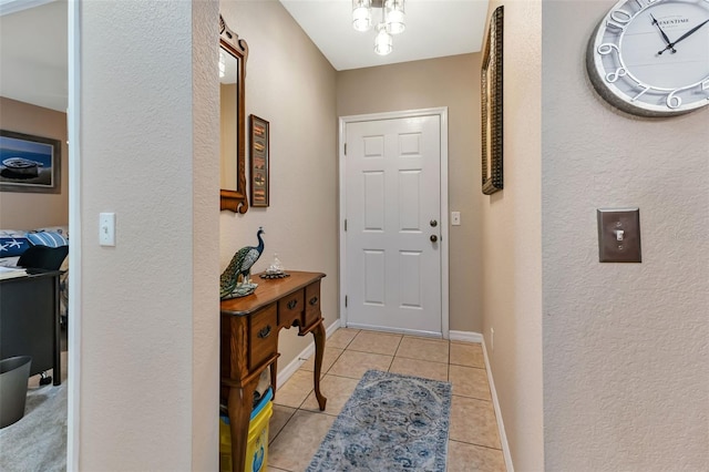 doorway featuring light tile patterned flooring